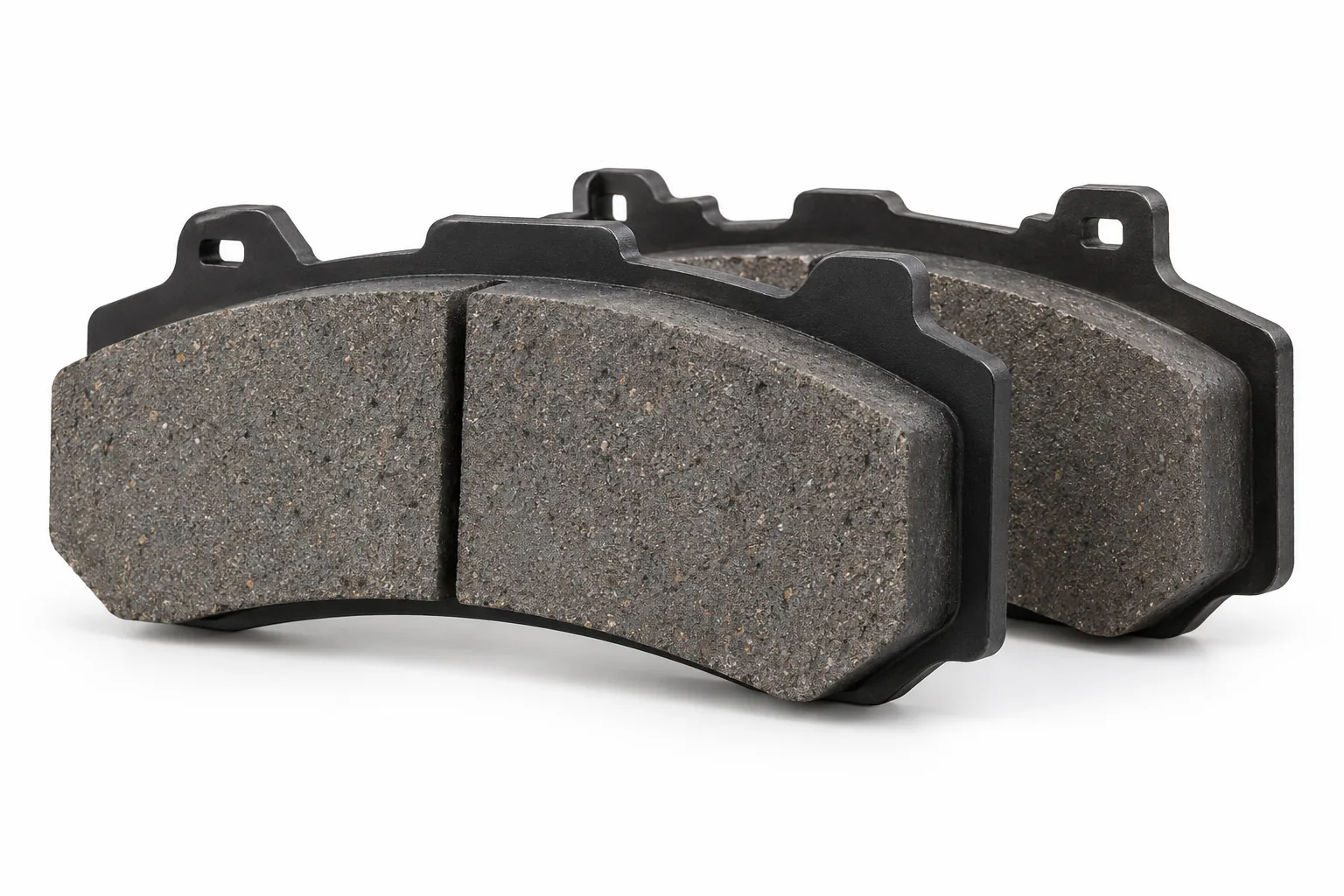 Image 4: AI-generated representative commercial brake pads, backing-plate view; not the actual used pads.