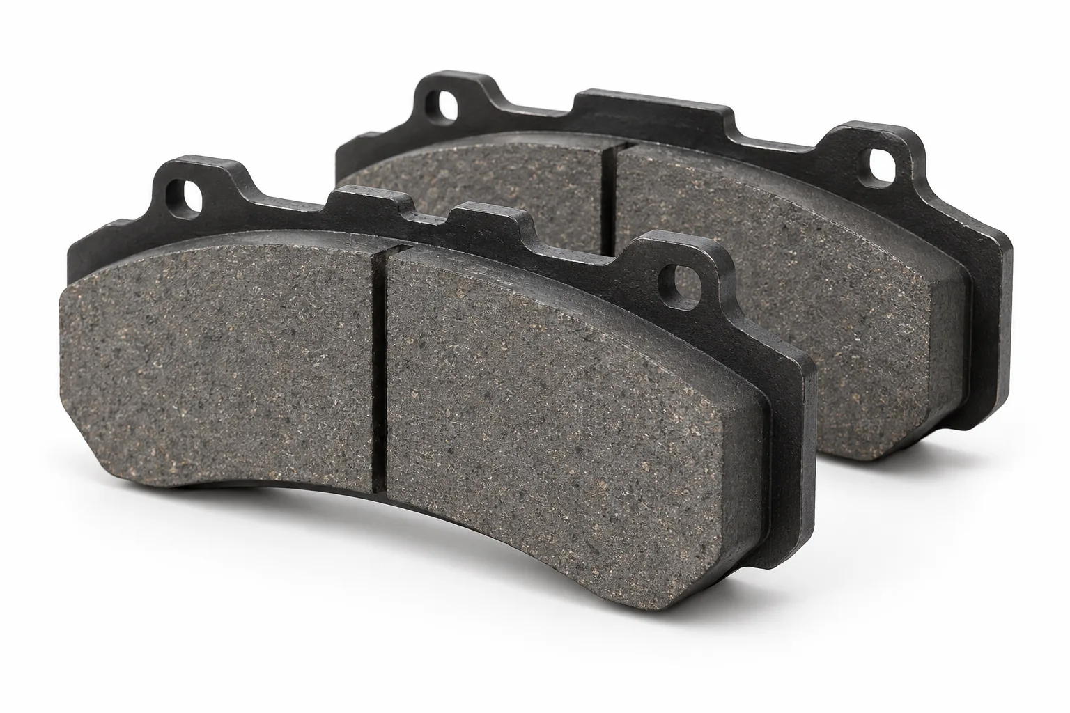 AI-generated representative commercial brake pads, front three-quarter view; not the actual used pads.